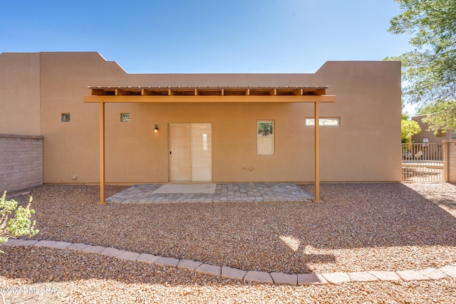 rear view of property featuring a patio