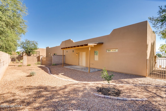 rear view of property featuring a patio