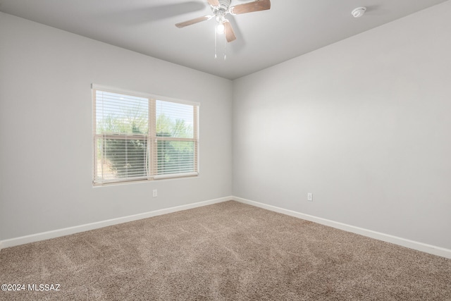 empty room with ceiling fan and carpet