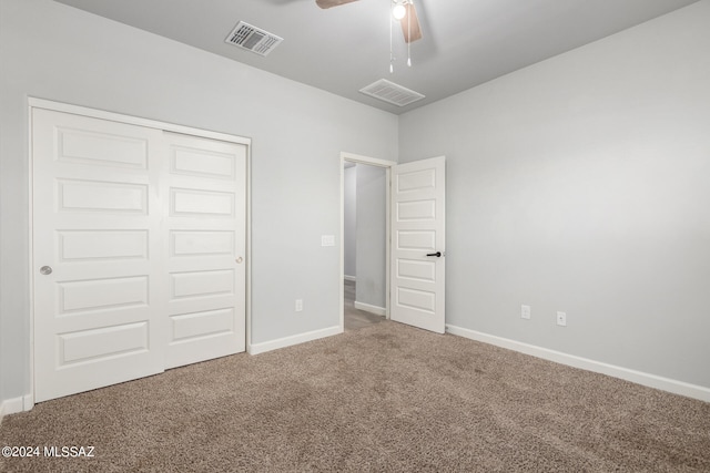 unfurnished bedroom with a closet, carpet floors, and ceiling fan