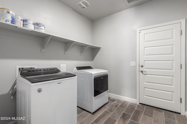 washroom featuring dark wood-type flooring and separate washer and dryer