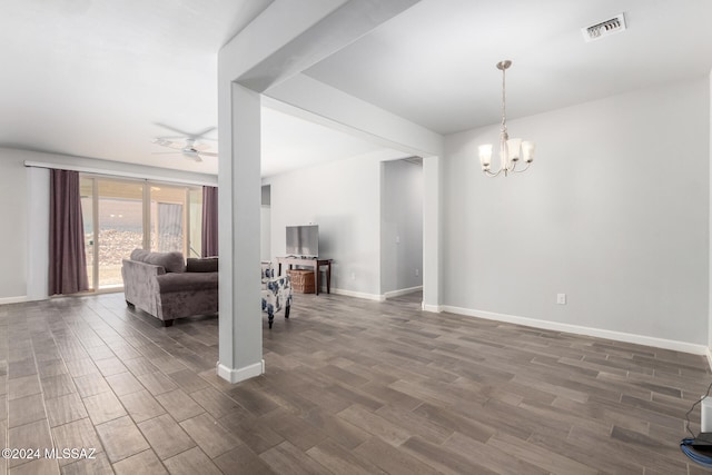 living room with dark wood-type flooring and ceiling fan with notable chandelier