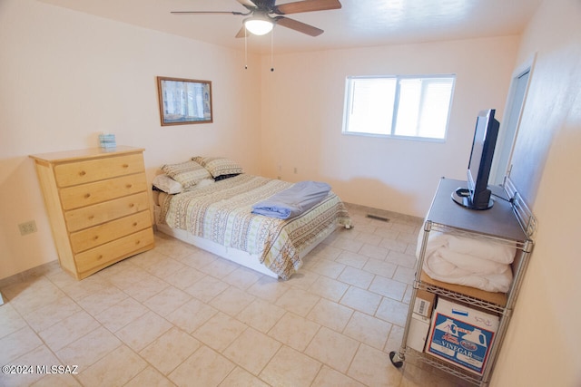 bedroom featuring light tile patterned floors and ceiling fan