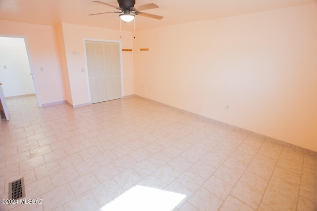 unfurnished room with light tile patterned floors and ceiling fan