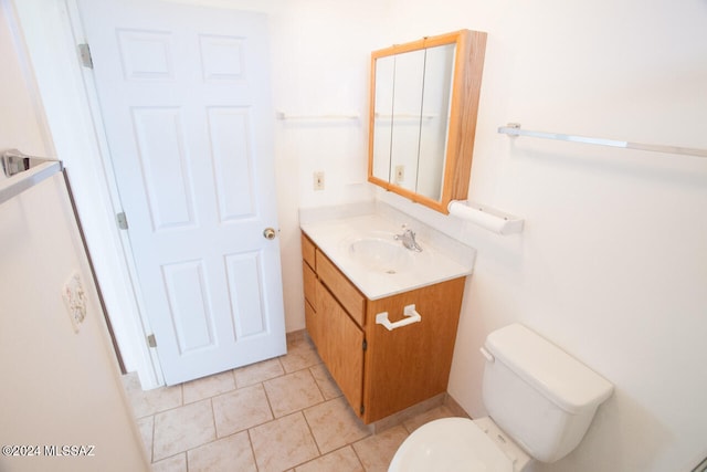 bathroom featuring vanity, tile patterned floors, and toilet