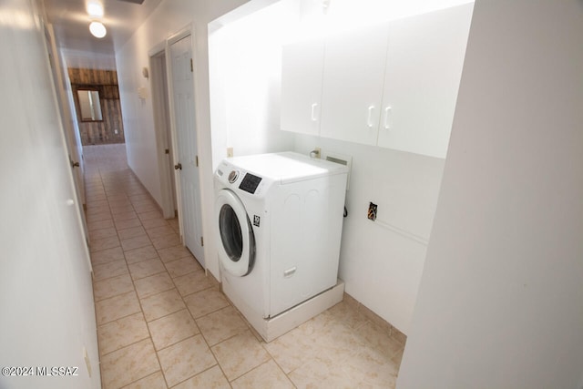 laundry room with washer / clothes dryer, cabinets, and light tile patterned flooring