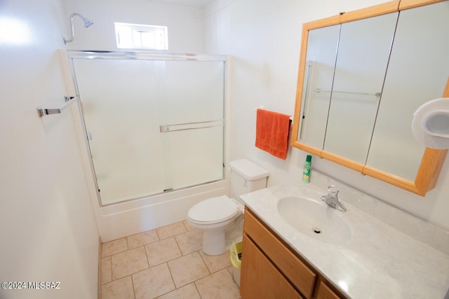 full bathroom with vanity, tile patterned floors, toilet, and combined bath / shower with glass door