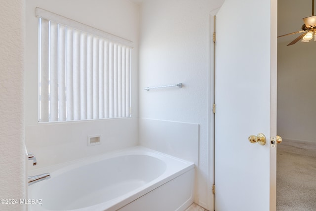 full bath with a ceiling fan and a garden tub