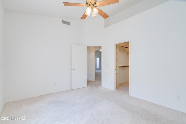 spare room with a ceiling fan, light colored carpet, and visible vents