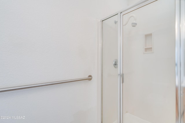 bathroom with a shower with door