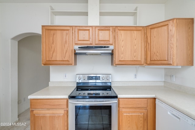 kitchen with light brown cabinetry, tile patterned floors, dishwasher, and stainless steel range with electric cooktop