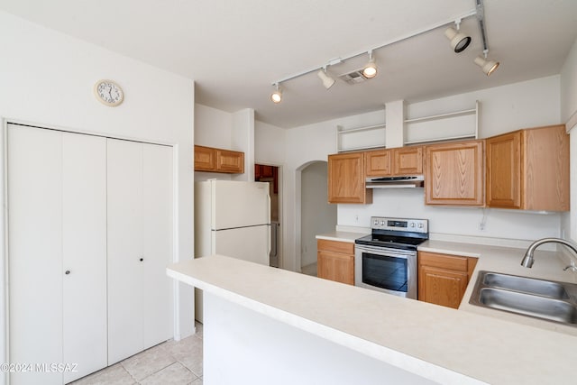 kitchen with light tile patterned floors, rail lighting, stainless steel electric range oven, sink, and white refrigerator