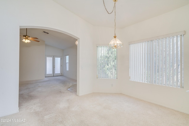 unfurnished room featuring lofted ceiling, carpet flooring, and ceiling fan with notable chandelier