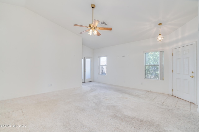 empty room featuring high vaulted ceiling, light colored carpet, a healthy amount of sunlight, and ceiling fan