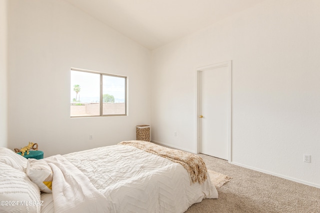 bedroom featuring carpet and vaulted ceiling