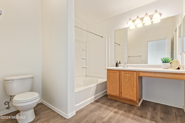 full bathroom with hardwood / wood-style flooring, vaulted ceiling, toilet, vanity, and shower / bath combination