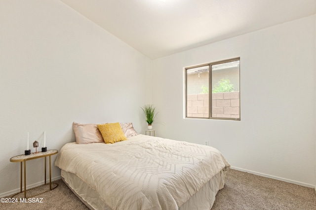 carpeted bedroom featuring vaulted ceiling