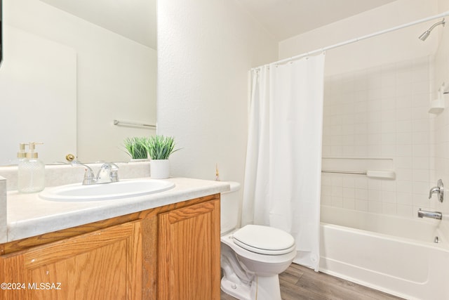 full bathroom with vanity, hardwood / wood-style floors, toilet, and shower / bath combo