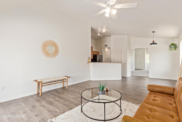 living room featuring ceiling fan, wood-type flooring, and lofted ceiling