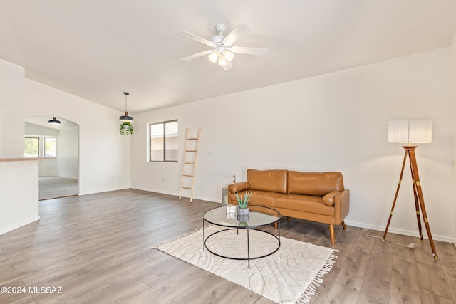 living room featuring wood-type flooring and ceiling fan