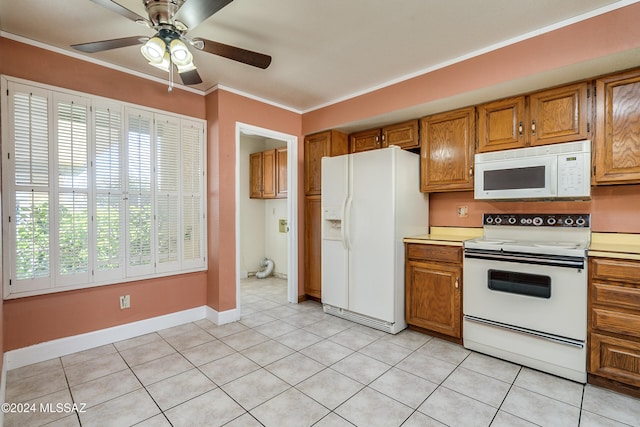 kitchen with white appliances, crown molding, light tile patterned floors, and ceiling fan