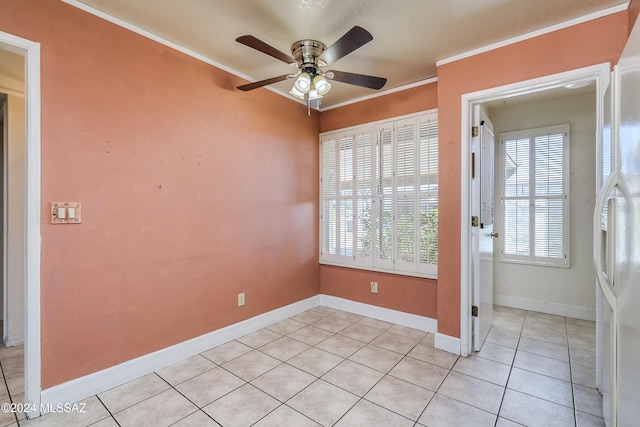 empty room with crown molding, light tile patterned flooring, and ceiling fan
