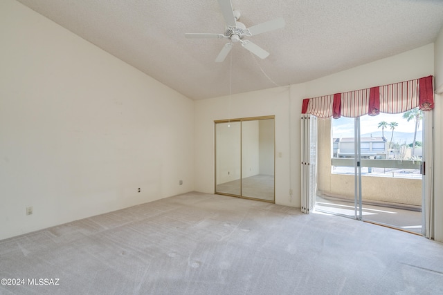 unfurnished bedroom with a textured ceiling, carpet floors, a closet, and ceiling fan