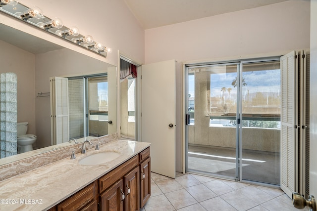 bathroom featuring toilet, vanity, and tile patterned floors