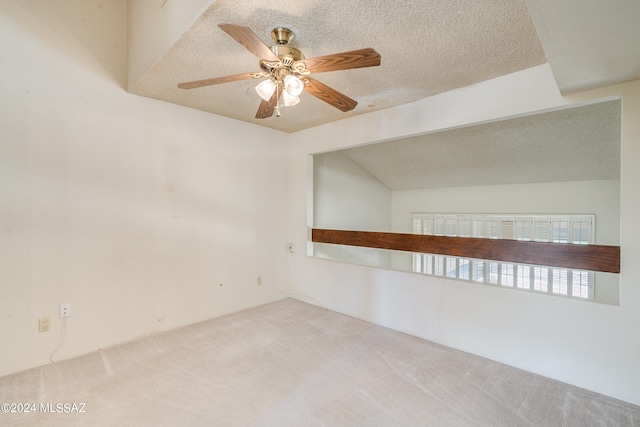 carpeted spare room with a textured ceiling and ceiling fan
