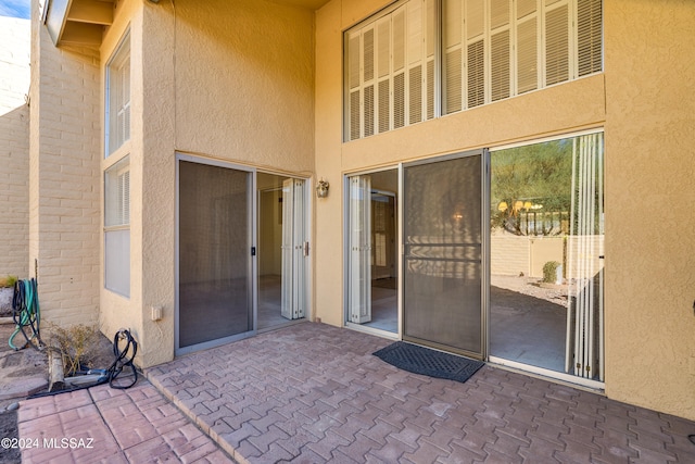 entrance to property featuring a patio