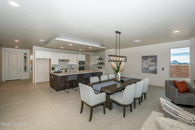 dining room with a notable chandelier and light tile patterned floors