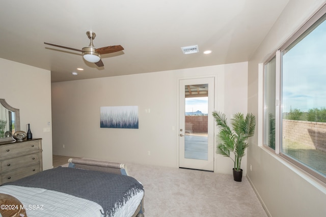 bedroom featuring light carpet, access to outside, and ceiling fan