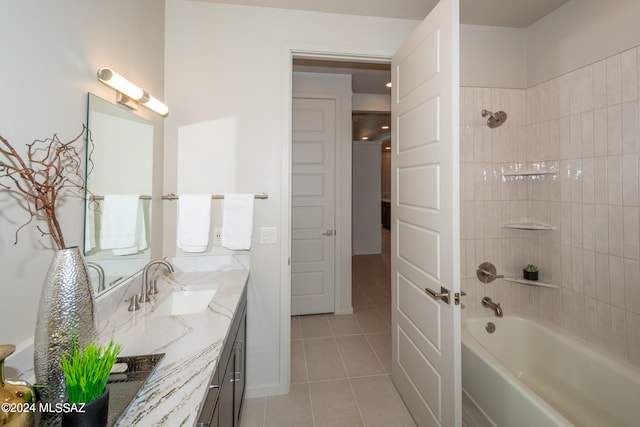 bathroom with vanity, tiled shower / bath combo, and tile patterned flooring