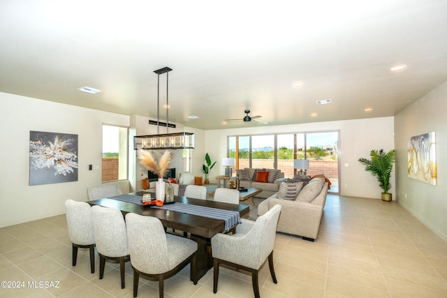 dining space featuring ceiling fan and light tile patterned floors