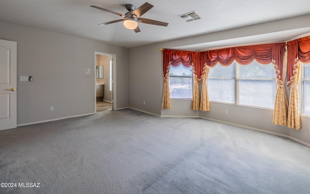 spare room featuring carpet and ceiling fan