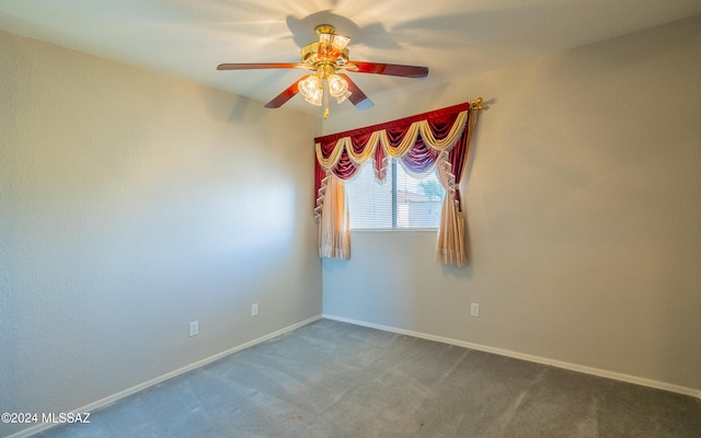 carpeted empty room featuring ceiling fan