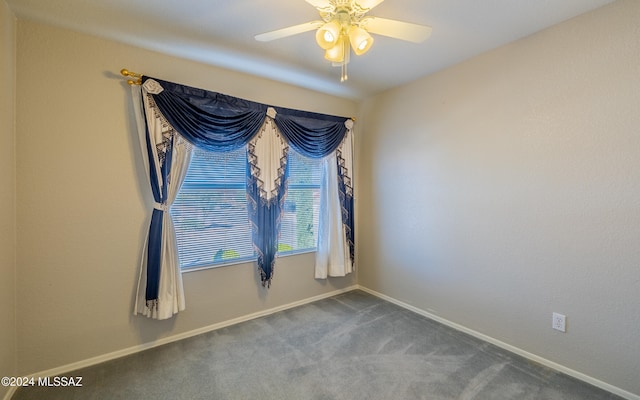 carpeted spare room featuring ceiling fan