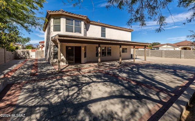 rear view of house featuring a patio