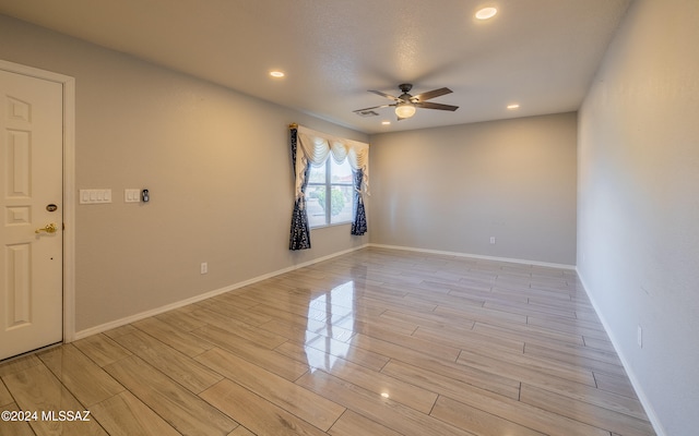 spare room with light hardwood / wood-style floors and ceiling fan