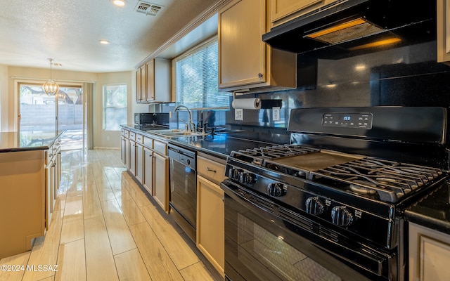 kitchen with hanging light fixtures, backsplash, a textured ceiling, black appliances, and sink