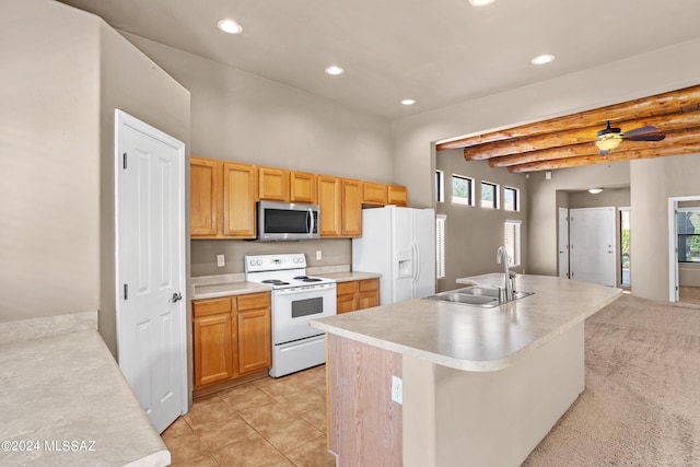 kitchen featuring beam ceiling, a center island with sink, sink, light tile patterned floors, and white appliances