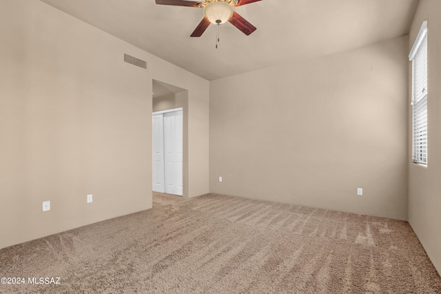 spare room featuring ceiling fan and carpet floors