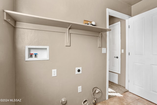 laundry area featuring washer hookup, hookup for a gas dryer, light tile patterned floors, and hookup for an electric dryer