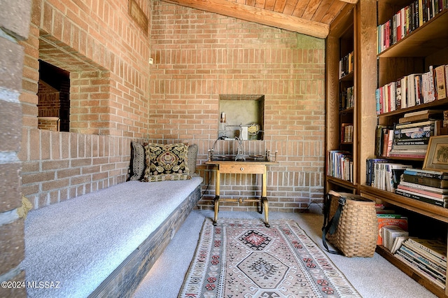 interior space with lofted ceiling, wooden ceiling, brick wall, carpet, and built in shelves