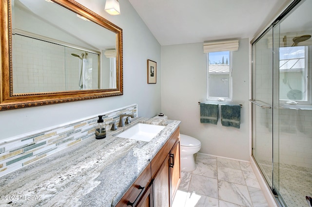 bathroom with decorative backsplash, walk in shower, vaulted ceiling, toilet, and vanity