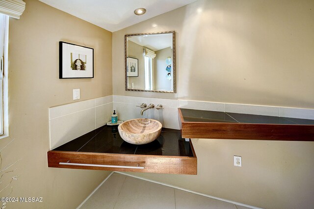 bathroom featuring sink and vaulted ceiling