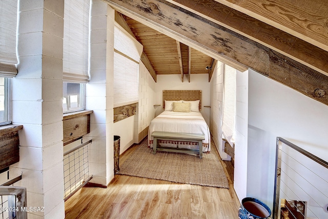 bedroom featuring wood ceiling, light hardwood / wood-style flooring, and vaulted ceiling with beams