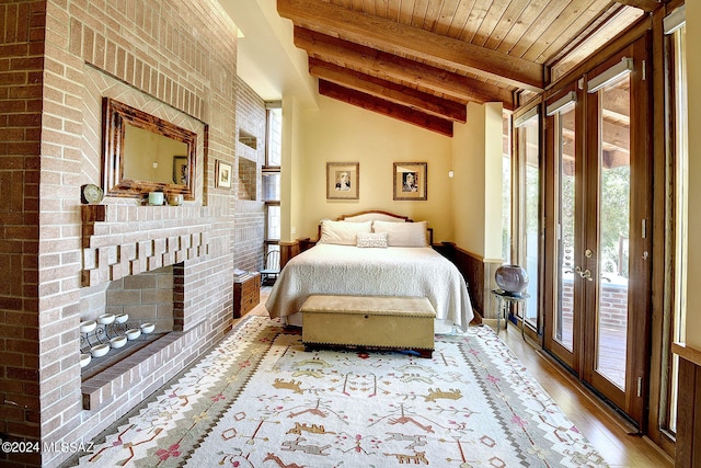 bedroom featuring multiple windows, access to exterior, and wood ceiling