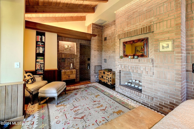 sitting room with wood ceiling, wood walls, lofted ceiling with beams, and brick wall