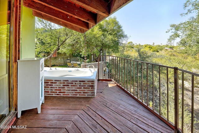 wooden deck with a hot tub